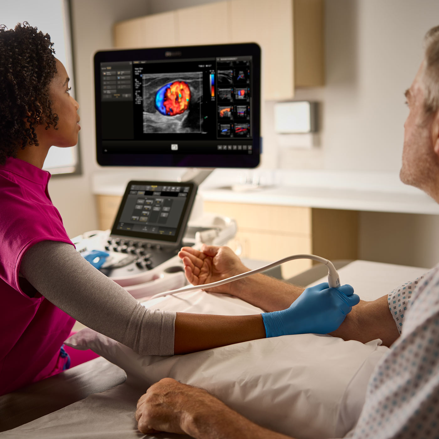 A healthcare professional uses ultrasound to capture images of a patient