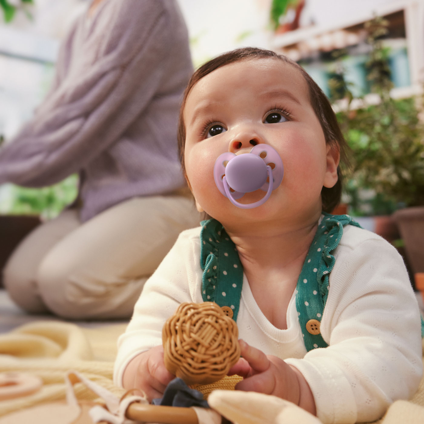 A baby with a pacifier in their mouth